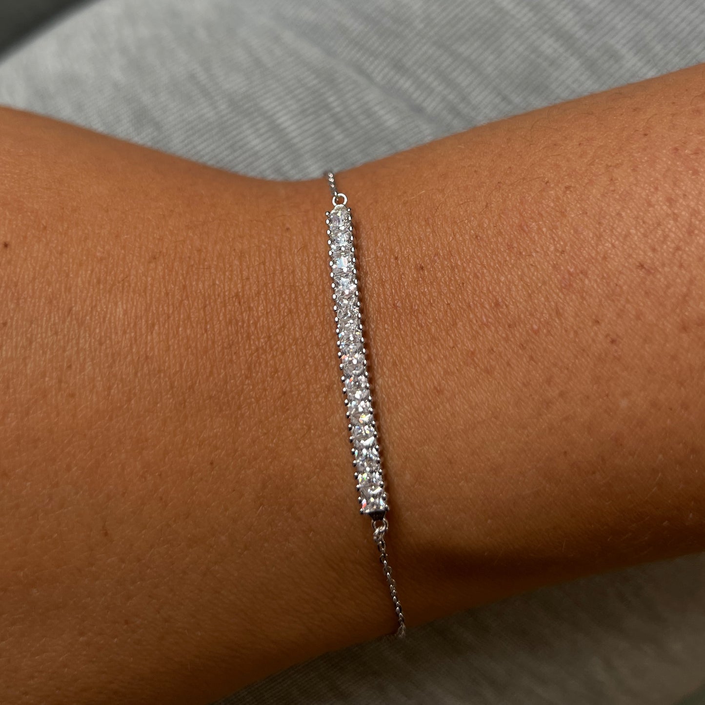 Princess cut cubic zirconia set in a dainty design.
