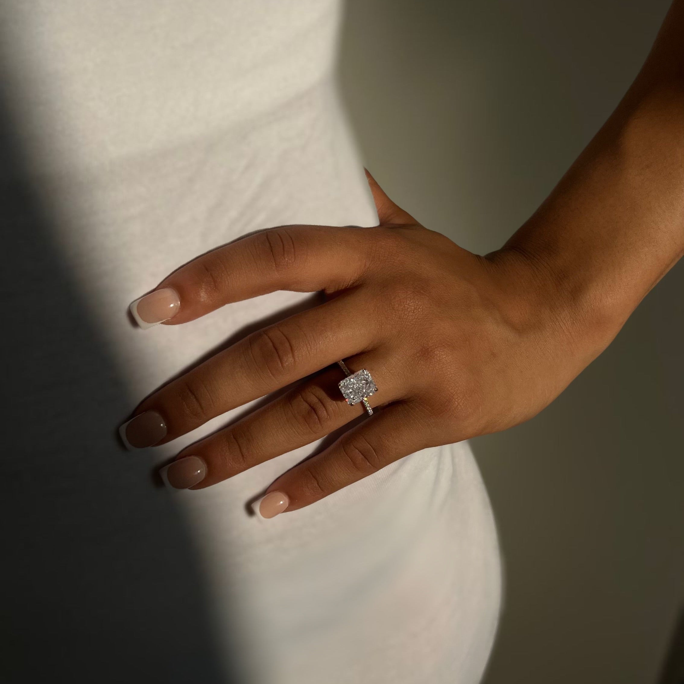 Kira ring sparkling in natural light on finger